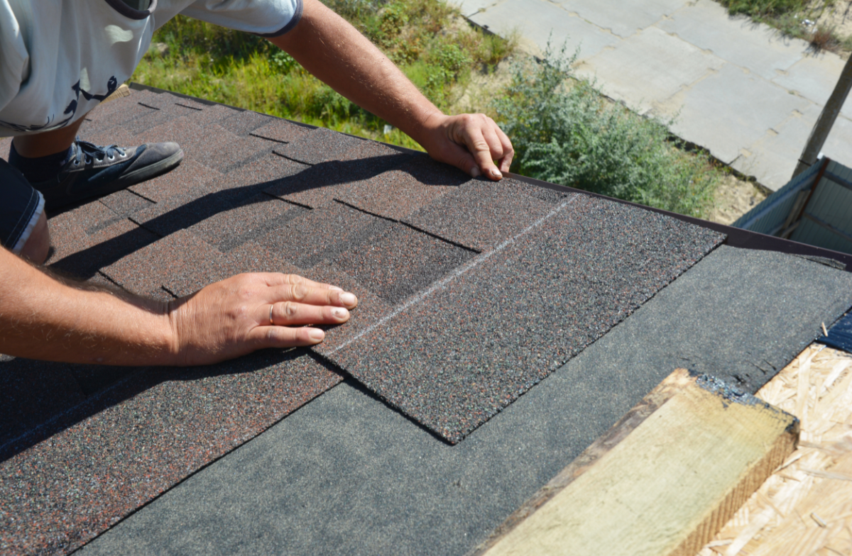 Professional shingle installation hands closeup