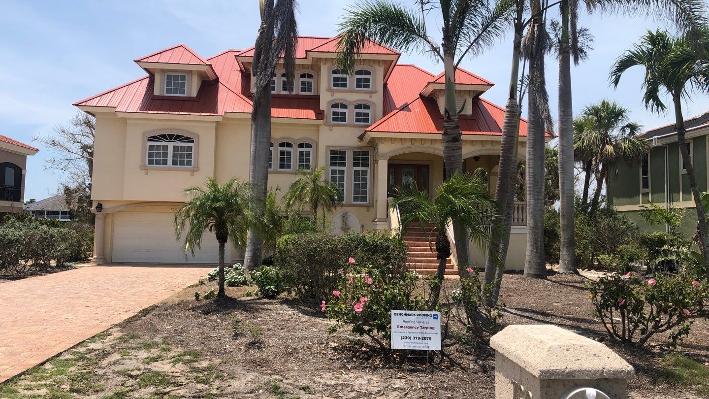 Red metal roof luxury home installation