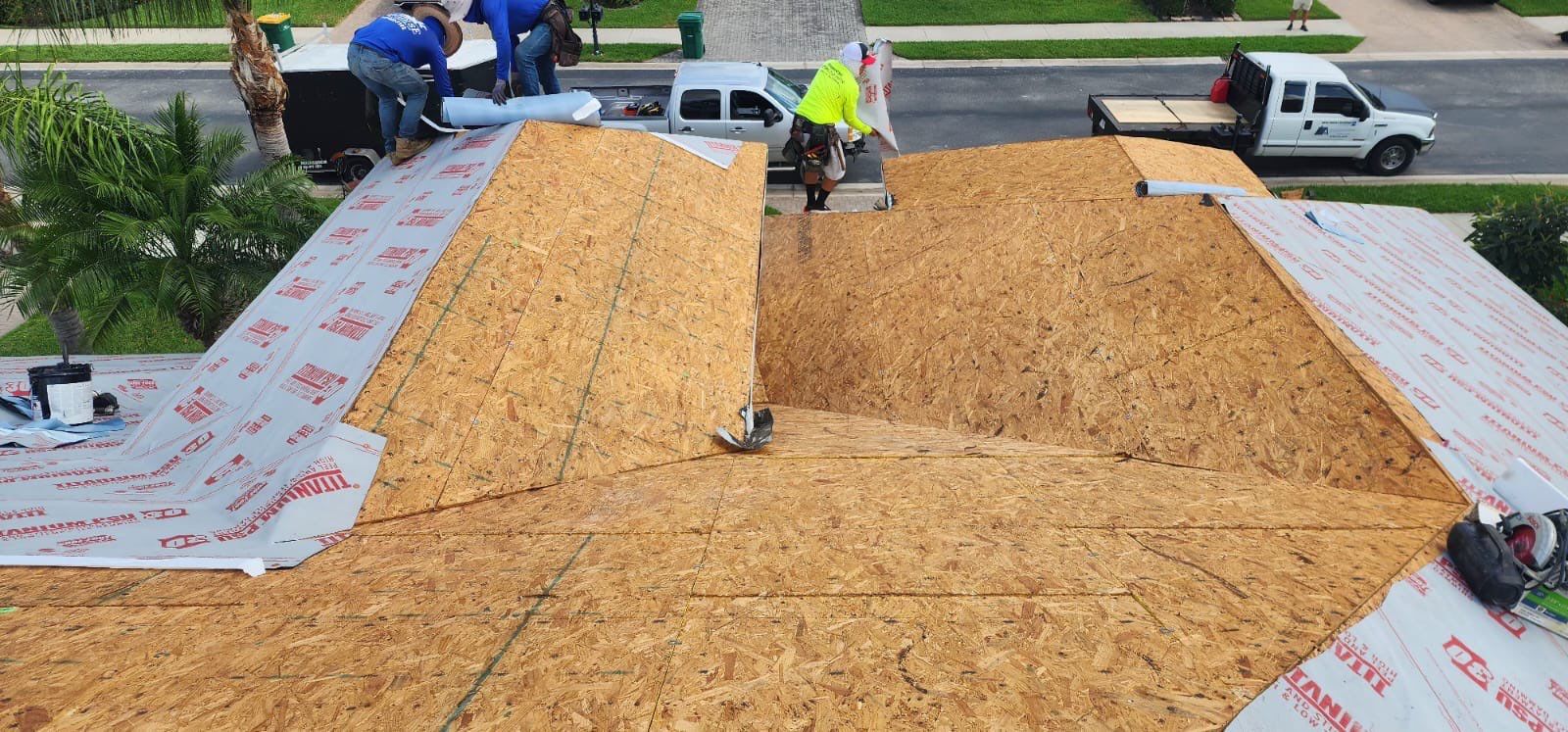 Plywood roof deck workers installation aerial view