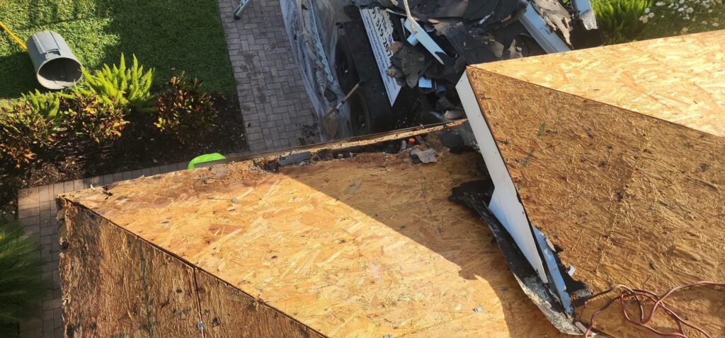 Brown shingle roof residential workers at work