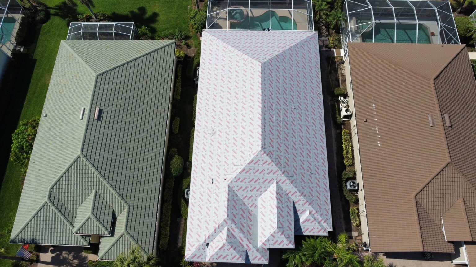 Aerial view of white, gray, and brown residential tile roofs