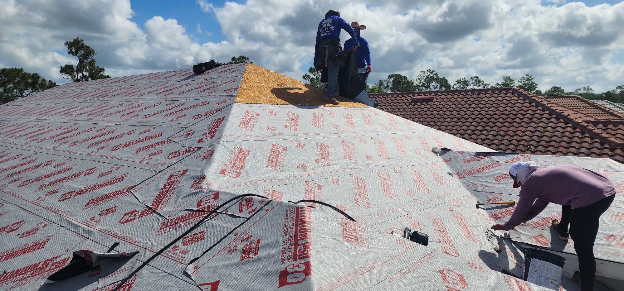 Multiple crew members installing underlayment professionally